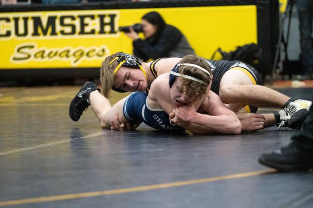 Tecumseh's Carter Hadsall works to flip Shawnee's Garett Ishman in the Tecumseh match on Feb. 9. The Wolves won 55-20. Photo provided by Kenetta Lisenbee.