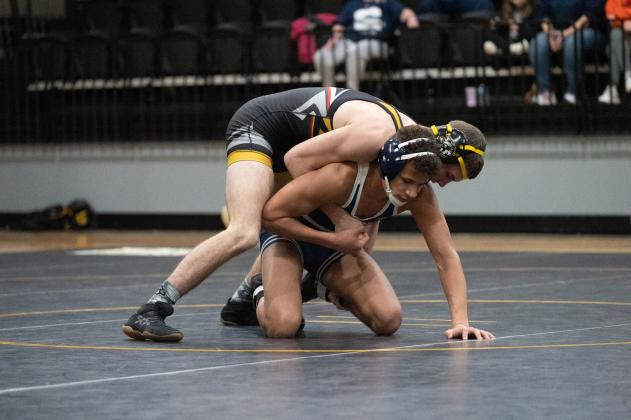 Tecumseh's J.D. Sigman works to pin Shawnee's Kade Carter in the Tecumseh match on Feb. 9. The Wolves won 55-20. Photo provided by Kenetta Lisenbee.