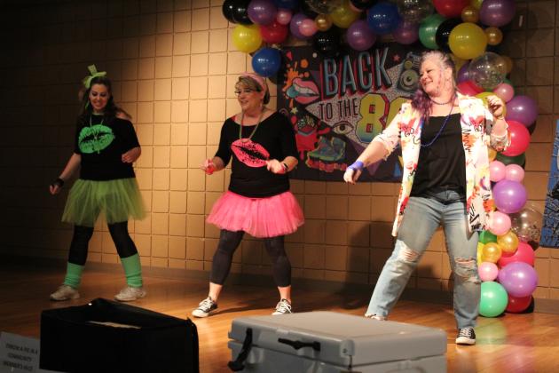 Tecumseh Chamber of Commerce Event Chair Becky Webb, Board President Kellie Clay, and Executive Director Kimberly Elliott dance to “Footloose” during the Annual Auction on Feb. 23. The theme for the event was “Back to the 80s.”