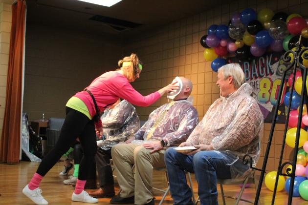 Tecumseh  Internship Program Coordinator Pam Robinson gives Tecumseh Superintendent Robert Kinsey a whipped cream "pie" in the face at the Tecumseh Chamber of Commerce Auction on Feb. 23. Tickets were drawn for the opportunity to pie Kellie Clay, Becky Webb, J.R. Kidney, Kinsey or Randy Gilbert. Countywide &amp; Sun/Natasha Dunagan