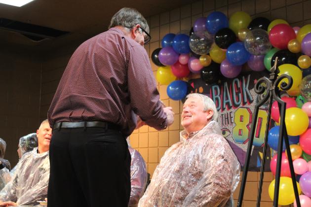 Veterinarian Dr. Bob Evans prepares to "pie" Randy Gilbert in the face during the Tecumseh Chamber of Commerce Auction on Feb. 23. Tickets were drawn for the opportunity to pie Kellie Clay, Becky Webb, J.R. Kidney, Robert Kinsey or Gilbert. Countywide &amp; Sun/Natasha Dunagan