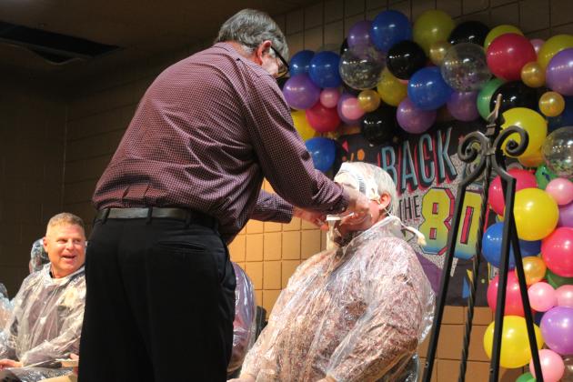 Veterinarian Dr. Bob Evans applies a "pie" to Randy Gilbert's face during the Tecumseh Chamber of Commerce Auction on Feb. 23. Tickets were drawn for the opportunity to pie Kellie Clay, Becky Webb, J.R. Kidney, Robert Kinsey or Gilbert. Countywide &amp; Sun/Natasha Dunagan