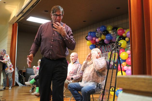 Veterinarian Dr. Bob Evans licks whipped cream from. his fingers after applying a “pie” to Randy Gilbert’s face during the Tecumseh Chamber of Commerce Auction on Feb. 23. Tickets were drawn for the opportunity to pie Kellie Clay, Becky Webb, J.R. Kidney, Robert Kinsey or Gilbert. Countywide &amp; Sun/Natasha Dunagan