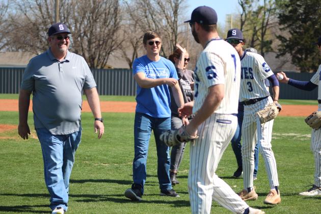 Four Arvest Bank associates threw out the first ball(s) for Shawnee High School’s first home baseball game on March 4, then got fist bumps from the team. Arvest was the largest sponsor and bought naming rights to the new electronic scoreboard. Shown, from left, are Community Bank President Brian Nave, Assistant V.P. and Business Banker David Dinsmore, Senior V.P. and Branch Administrator Jill Rawls., and Senior V.P. and Senior Client Advisor Kirk Israel. Countywide &amp; Sun/Natasha Dunagan