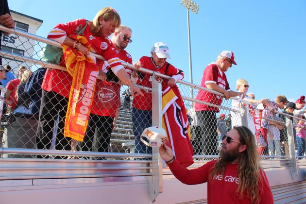 Verna Brooks, of Shawnee, hands Shawnee City Commissioner Travis Flood a hat which belonged to her father, Roy Slavin. Flood agreed to have Kansas City Chiefs Center Creed Humphrey sign one thing for Brooks and her mother, Julia Slavin, far left, during the Creed Humphrey Day Celebration on March 4. Brooks said her mother, age 90, has been a Chiefs fan for 60 years, and her parents had season tickets for 25 years. Her father was also a Citizen Potawatomi Nation tribal leader for 12 years.