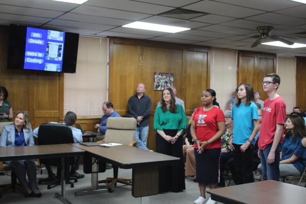 Coding teacher Krista Farris introduced three of her eighth-grade students in the new App Creator class at Shawnee Middle School, and they explained their projects to the Shawnee Board of Education, March 6. They are, from left, Amaya Townes, Duke Wright and Cooper Dunn. Countywide &amp; Sun/Natasha Dunagan