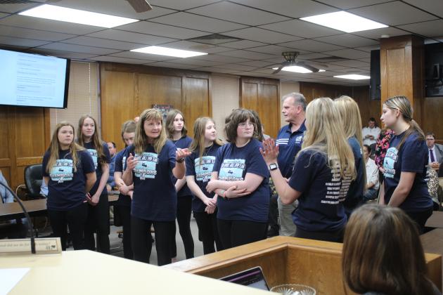 During the Shawnee Board of Education meeting, March 6, Head Swim Coach Valarie Colburn introduces the SHS Girls Swim Team, including Piper McNeil, hand raised, who broke two records at the 5A State Championship. This was the second year in a row for the girls team to win the state championship, as well. Countywide &amp; Sun/Natasha Dunagan