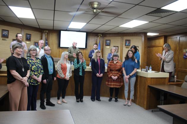 The Shawnee Board of Education applauds the 2023 Teachers of the Year during their March 6 meeting The site teachers, from left, are Dana Boyer, of Shawnee Early Childhood Center; Terri Mastin,of Horace Mann Elementary; Justin Hudlow, of Jefferson Elementary;  Kasey Clark, of Will Rogers Elementary; Trecia Leach, of Shawnee Middle School; Tammy Cooper, of Shawnee High School; and Mary Cash, of Jim Thorpe Academy. Shown, far right, is District Teacher of the Year, Roxie Beggs, of Sequoyah Elementary.