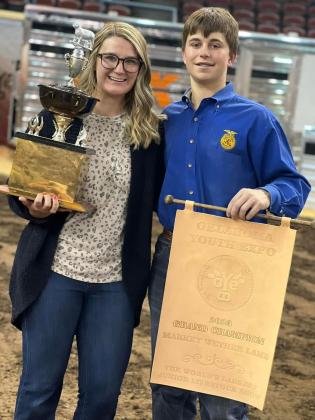 Bethel's Connor Anthony poses, along with his mother Sara Goggins, with his trophy and banner after winning the Oklahoma Youth Expo Grand Champion Market Wether Lamb. Photo provided.
