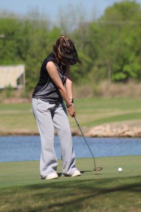 Tecumseh junior Angel Duggan putts at the fifth hole during the Tecumseh Girls Golf Invitational on April 18. Duggan scored 105 at the tournament. Countywide &amp; Sun/Natasha Dunagan