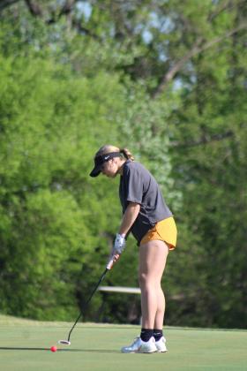 Tecumseh freshman Kyrie Aultman putts at the fifth hole of FireLake Golf Course during the Tecumseh Girls Golf Invitational on April 18. Aultman scored 127 at the tournament. Countywide &amp; Sun/Natasha Dunagan