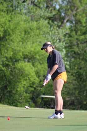 Tecumseh freshman Kyrie Aultman putts at the fifth hole of FireLake Golf Course during the Tecumseh Girls Golf Invitational on April 18. Aultman scored 127 at the tournament. Countywide &amp; Sun/Natasha Dunagan
