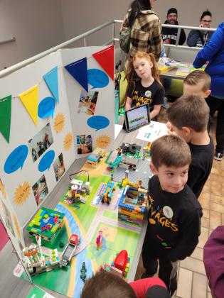 The Barnard Elementary LEGO Savages participate in a qualifying event held at Gordon Cooper Technology Center last fall, where they received the Core Values Award. From a "Super Power" LEGO kit, they have built a working windmill, a battery-storage machine and a shark machine, along with a complete environment. Photo provided.