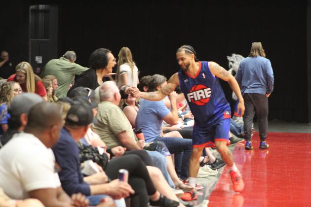 Potawatomi Fire Guard Tevin Foster takes a minute to shake hands with Citizen Potawatomi Nation Vice Chair Linda Capps during the home game on April 13. Countywide &amp; Sun/Natasha Dunagan