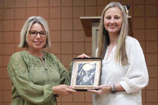 Tecumseh Assistant Superintendent Brandi Burks presents Jennifer Wiens with the Presidents' Award.
