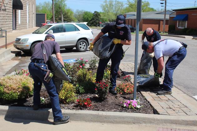 Four Tecumseh firefighters help with the replanting of the 16 street corner gardens by spreading mulch on April 17. Shown, from left, are Dylan Taylor, Eddie Kidney, Fire Chief Rhett Banks, back, and Justin Hamby. Countywide &amp; Sun/Natasha Dunagan
