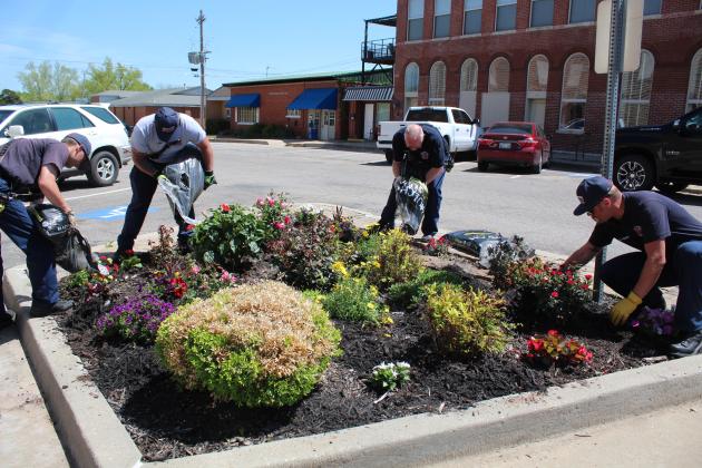 Four Tecumseh firefighters help with the replanting of the 16 street corner gardens by spreading mulch on April 17. Shown, from left, are Dylan Taylor, Eddie Kidney, Fire Chief Rhett Banks, back, and Justin Hamby. Countywide &amp; Sun/Natasha Dunagan
