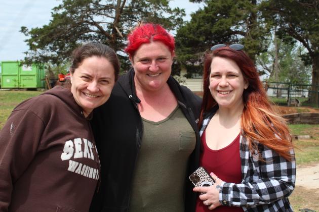 Corrie Graybill, Maeghan Olsen, and Bree Kim take a break from tornado cleanup for a photo at 1 Day Ranch Rescue, in Bethel.