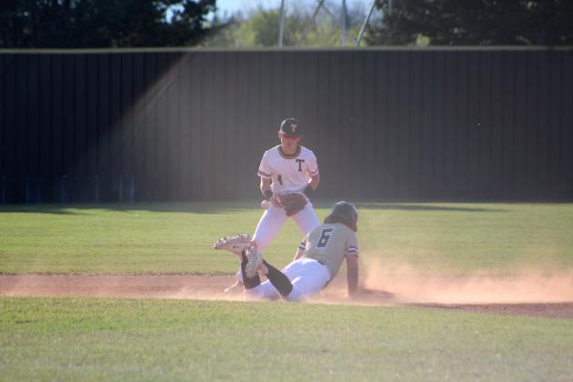 Tecumseh junior Bryson Smith tries to tag an Inola runner in the fourth inning of the home game on April 10. The Savages lost, 6-11. Countywide &amp; Sun/Natasha Dunagan