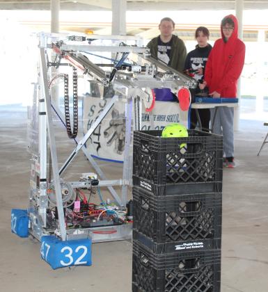 The Shawnee High School Robotics Team demonstrates how their robot can make a basket during the Touch-A-Truck and Beyond event on April 1. Shown are Casey Peters, Lilly Lackey and Michael Buchanan. Countywide &amp; Sun/Natasha Dunagan