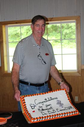 Dr. Bob Evans, DVM, holds up his retirement cake during a reception at Crossing Hearts Ranch on May 21. Evans founded Tecumseh Veterinary Clinic in 1978. Countywide &amp; Sun/Natasha Dunagan
