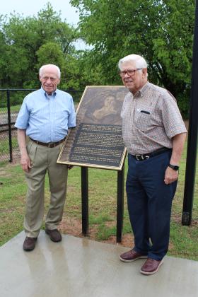 Shawnee 1957 graduates Danny Glenn and Walter Coffey stand by a bronze plaque dedicated to Glenn on May 4. After being shot down, Glenn spent six years at several Vietnamese POW camps. A bronze plaque was made with his story and is located outside of the Paul and Ann Milburn Center, in Shawnee. Countywide &amp; Sun/Natasha Dunagan