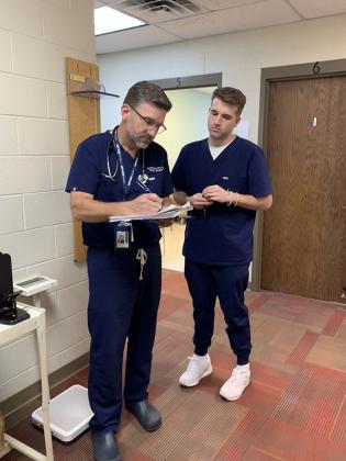 Dr. Scott Stewart looks over a chart with his son Parker.