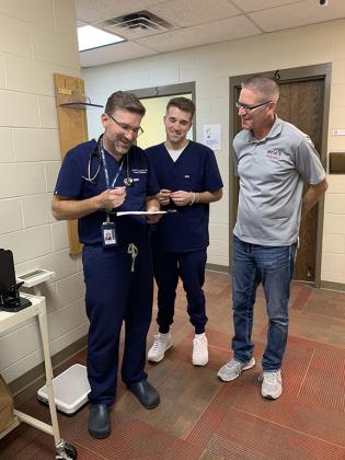 Dr. Scott Stewart, Parker Stewart, medical scribe, and Eric Winegardner, pharmacist.