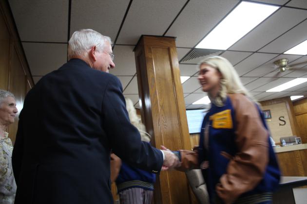 Larry Walker shakes hands with Piper McNeil.