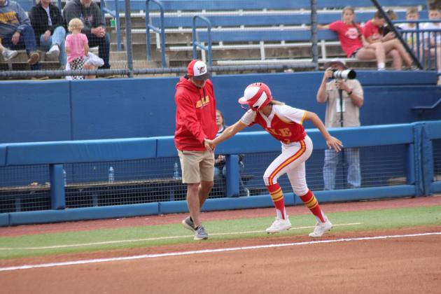 After hitting a home run, Dale senior Chayse Caram gets five from Coach Andy Powell as she rounds third base in the first inning of the Class 3A State Tournament Finals against Caddo on May 3. Countywide &amp; Sun/Natasha Dunagan