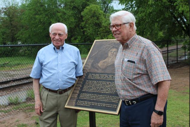 Shawnee 1957 graduates Danny Glenn and Walter Coffey stand by a bronze plaque dedicated to Glenn on May 4. After being shot down, Glenn spent six years at several Vietnamese POW camps. A bronze plaque was made with his story and is located outside of the Paul and Ann Milburn Center, in Shawnee. Countywide &amp; Sun/Natasha Dunagan