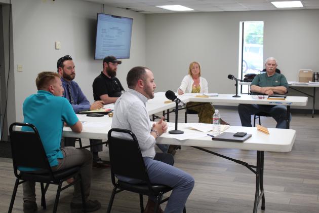 Pink Town Attorney Trent Guleserian answers questions during the Pink Zoning Board Special Meeting on May 8. The Zoning Board includes, clockwise from left, Patrick Holford, Tom Cooper, Danny Coker, Susan Givens and Jim Miller. Countywide &amp; Sun/Natasha Dunagan