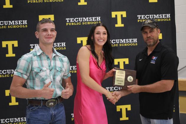 JD, left, and Billydon Sigman, far right, present the Andrea Sigman Memorial Scholarship to Kenzli Warden.
