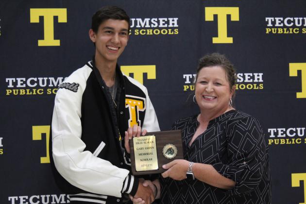 Track and Cross Country Coach Kortney Ozment presents the Gary Guinn Memorial Scholar/Athlete Award to Logan Haworth.