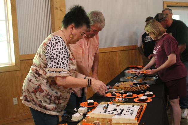 A retirement reception was held for Dr. Bob Evans, DVM, at Crossing Hearts Ranch on May 21, and there was a crowd on hand to wish him well, including the venue owners Randy and Suzanne Gilbert, shown serving cake. Countywide &amp; Sun/Natasha Dunagan