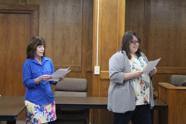Shawnee Director of Special Services Allyson Cleveland, left, and Director of Federal Grants Dr. Jenny Jasper read a poem written by Assistant Superintendent of Personnel Dr. Teresa Wilkerson about retiring Shawnee Superintendent Dr. April Grace at the June 26 Board of Education meeting. There was a question-and-response portion of the poem, with the answer always being, "I'll pray about it." Countywide &amp; Sun/Natasha Dunagan