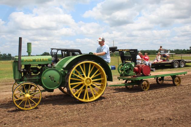 Chad Mercantine of McLoud drives his 1930's John Deere tractor in the antique tractor parade during the Farming Heritage Festival at Shawnee Feed on June 17. Hosted by the Shawnee Tractor and Engine Club, the event is in its 24th year and also included several farming demonstrations, tractor pulling, corn shelling and rope making, June 16 -17. Countywide &amp; Sun/Natasha Dunagan