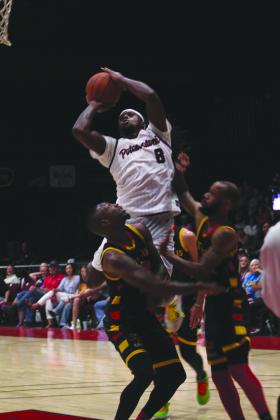 Potawatomi Fire Guard/Forward K.D. Moore soars over two Griffins to make a basket and get the foul in the third quarter of the second game during the TBL Finals with the St. Louis Griffins at FireLake Arena on June 26. They won 127-95 to force the third game on June 27. Countywide &amp; Sun/Natasha Dunagan