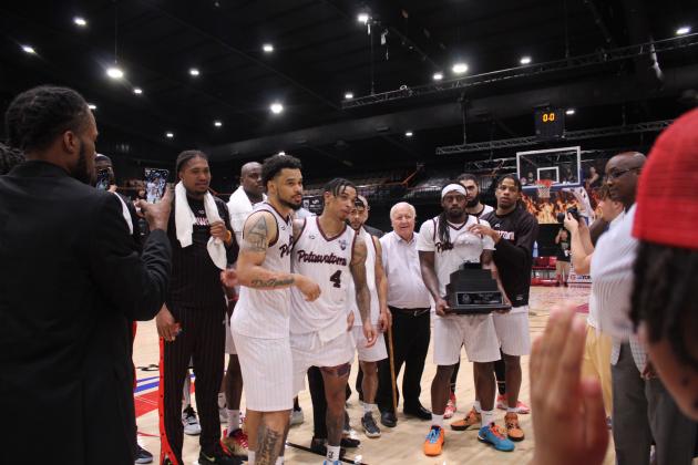As K.D. Moore holds "The Lillie," the national trophy for The Basketball League, Deshawn Munson and Chuck Guy share MVP honors after the Finals on June 27. Countywide &amp; Sun/Natasha Dunagan