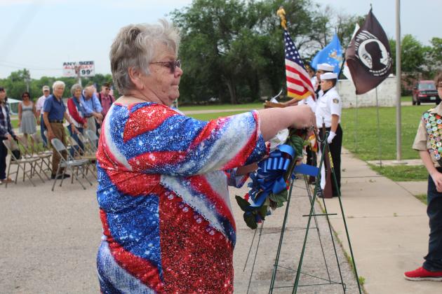 Tecumseh American Legion Auxiliary President Donna Snodgrass places a wreath for the fallen U.S. Army veterans. Nine wreaths were placed for the different military branches during the Memorial Day service at Tecumseh Cemetery on May 29. Countywide &amp; Sun/Natasha Dunagan