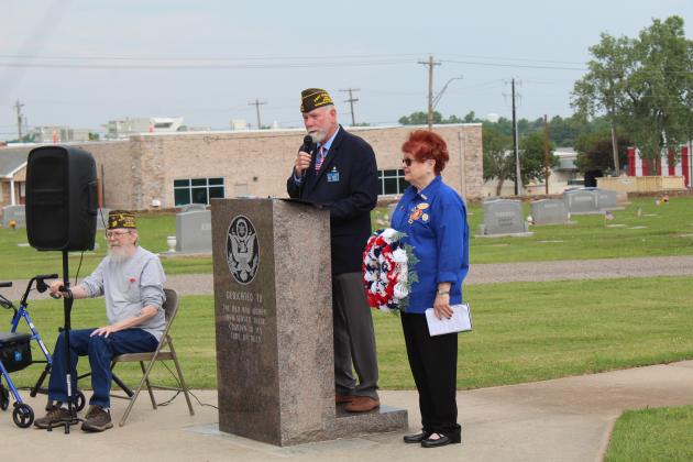Veterans of Foreign Wars Post 1317 Commander Patrick Koch speaks at the Memorial Day service at Fairview Cemetery in Shawnee on May 29. Also shown are Post Chaplain Danny Brown and VFW Auxiliary President Barbara White. Countywide &amp; Sun/Natasha Dunagan