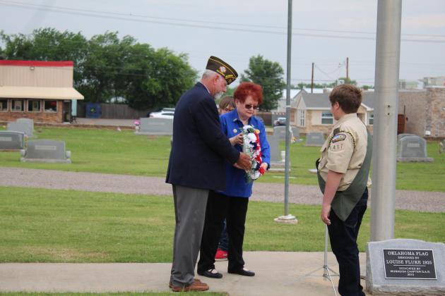 VFW Post 1317 Commander Patrick Koch and VFW Auxiliary President Barbara White place a wreath for all fallen soldiers during the Memorial Day service at Fairview Cemetery in Shawnee on May 29. Scouts Lucas Shafer and Robby Byrd, of Troop 417, look on.  Countywide &amp; Sun/Natasha Dunagan