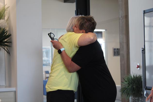 YMCA Livestrong Program graduate Pam Moulin shares a hug with Health and Wellness Director LaDawn Hladik after sharing her testimony during the program's first graduation ceremony, held at First United Bank in Shawnee on June 8. Countywide &amp; Sun/Natasha Dunagan