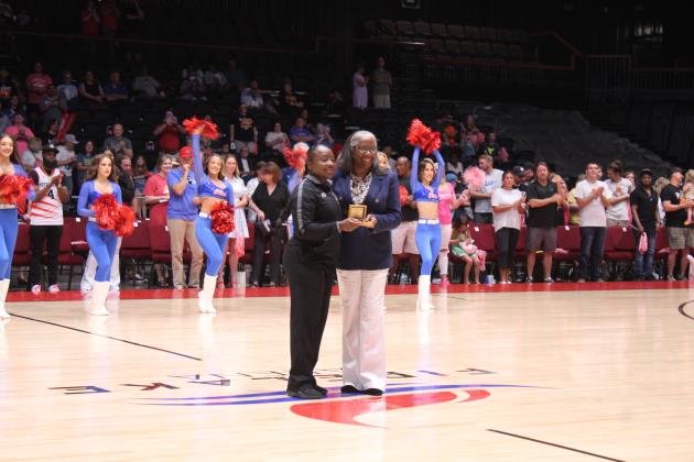 Referree Crystal Weeks, left, accepts the Referree of the Year award from The Basketball League CEO Evelyn Magley before the Central Conference Regional game at FireLake Arena on June 19. Weeks is the first female recipient of the award and served as the crew chief for the game. Countywide &amp; Sun/Natasha Dunagan