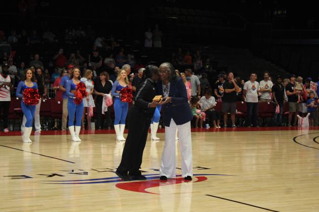 Referree Crystal Weeks, left, accepts the Referree of the Year award from The Basketball League CEO Evelyn Magley before the Central Conference Regional game at FireLake Arena on June 19. Weeks is the first female recipient of the award and served as the crew chief for the game. Countywide &amp; Sun/Natasha Dunagan