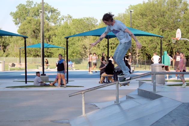 Evan McCullough, who recently moved to Tecumseh, performs a railslide on the skate park portion of KidSpace Park during the Grand Opening on June 23. The skate park existed before the park's renovation, but had a few repairs. Countywide &amp; Sun/Natasha Dunagan