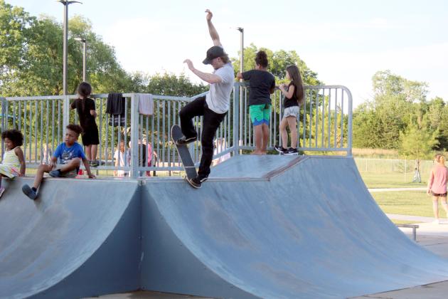 Tim Carr, of Shawnee, performs a "rock n' roll" trick during the skateboarding demonstration at KidSpace Park's Grand Opening, June 23. The skate park existed before the park's renovation, but had a few repairs. Countywide &amp; Sun/Natasha Dunagan