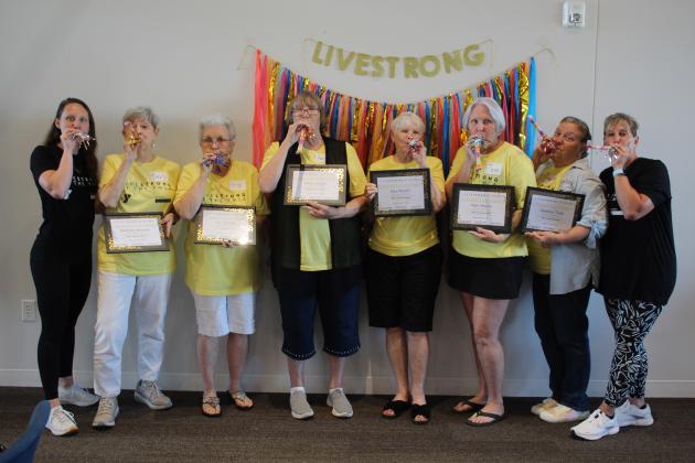 The first graduating class of the YMCA Livestrong Program, along with their teachers, celebrate with party favors on June 8 at First United Bank in Shawnee. Shown, from left, are Assistant Health and Wellness Coordinator Tate Mocabee, Barbara Morrow, Iris Morrow, Gayla Casey, Kay Moulin, Pam Moulin, Heather Todd and Health and Wellness Director LaDawn Hladik. Countywide &amp; Sun/Natasha Dunagan