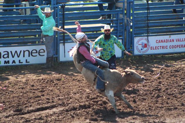 Jeffrey Bixler of Marshall, AR, competes in bull riding on July 10.