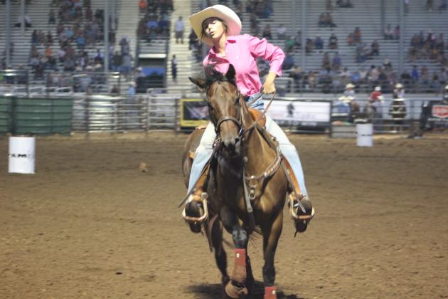 Bella Branham of Tecumseh slows her horse after their barrel ride at the International Finals Youth Rodeo on the evening of July 10. Countywide &amp; Sun/Natasha Dunagan